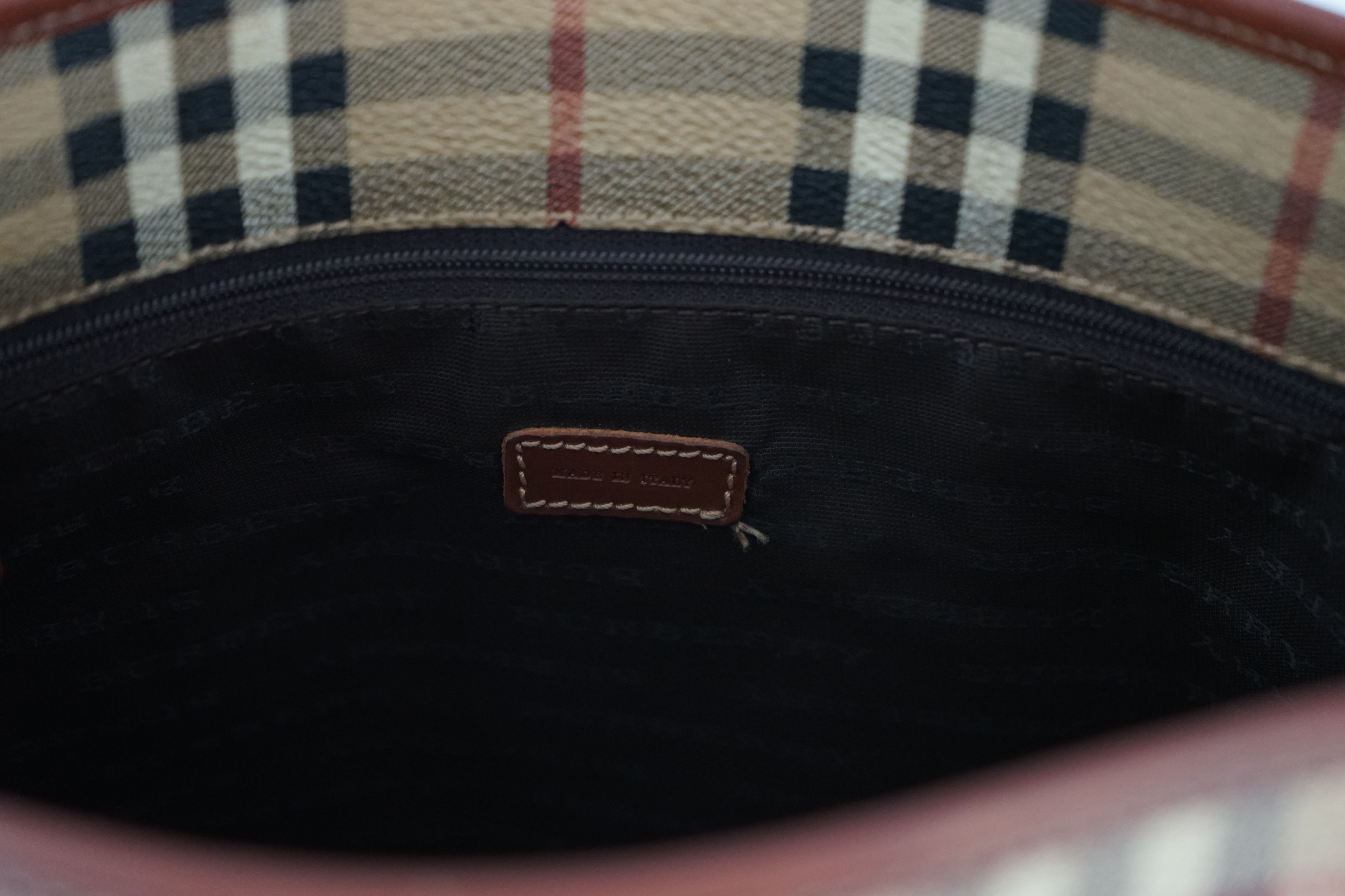 A Burberry Beige/Brown Haymarket coated canvas and leather bucket bag, wallet, cosmetic pouch and small zip case Bag: width 28cm, depth16cm, height 28cm. Wallet: width 20cm, depth 2cm, height 10cm. Cosmetic pouch: width1